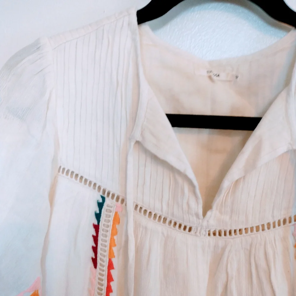 Tularosa Ingrid embroidered boho top from Revolve.  Has tassels in the front and
